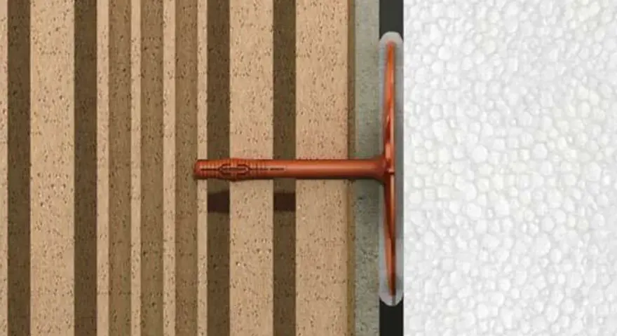 Cheville ite fixée dans un mur isolant en polystyrène expansé, montrant la fixation d'un élément sur une structure isolée.